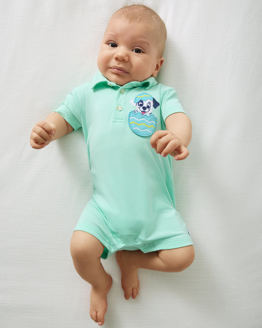 Aerial view of baby wearing the Disney Peekaboo Pets Polo Shorty Romper
