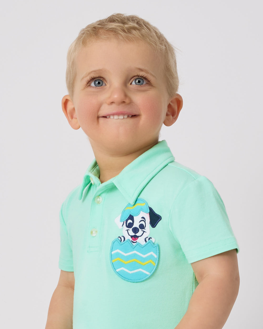 Close up of child wearing the Disney Peekaboo Pets Polo Shorty Romper