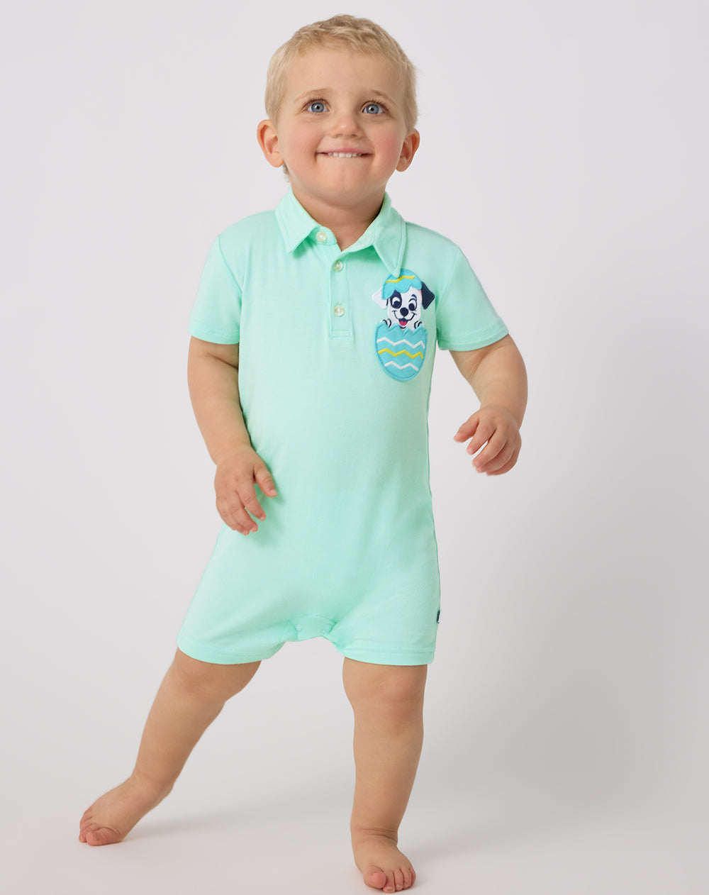 Standing toddler wearing the Disney Peekaboo Pets Polo Shorty Romper