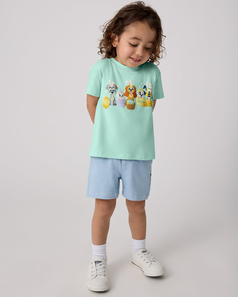 Boy wearing the Disney Peekaboo Pets Relaxed Tee with blue chino shorts