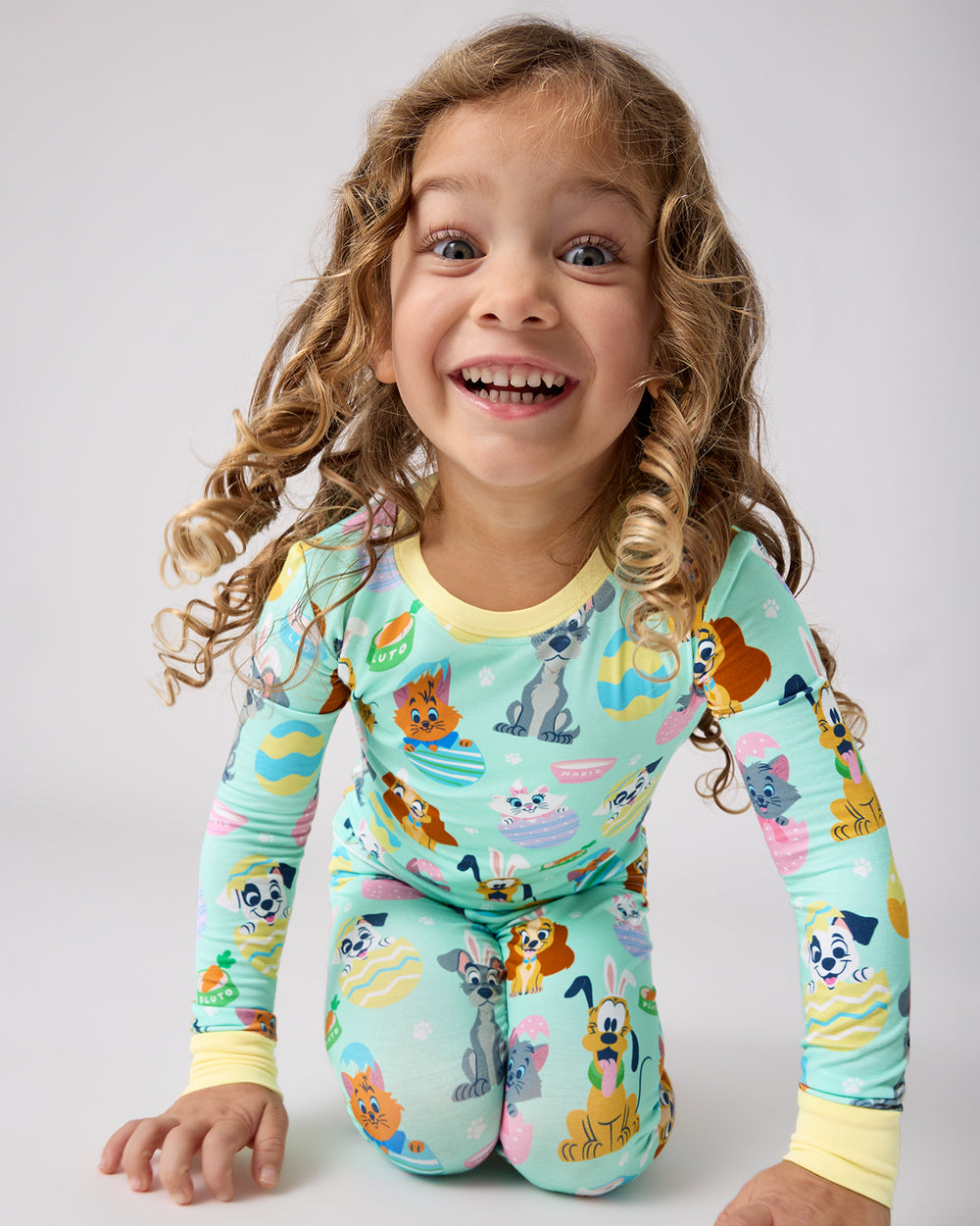 Sitting child wearing the Disney Peekaboo Pets Two-Piece Pajama Set