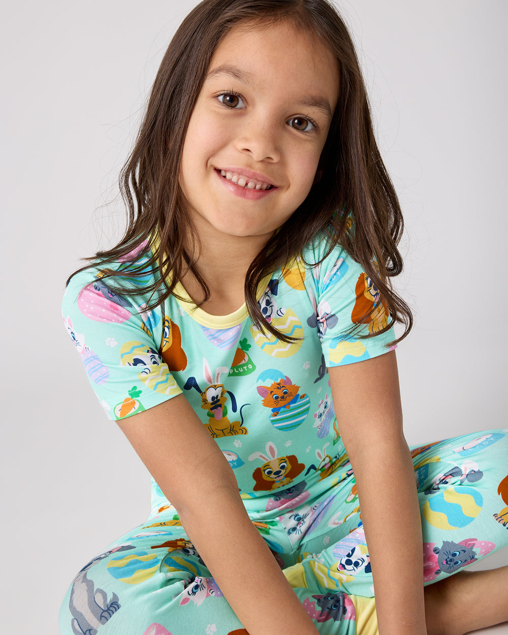 Close up of sitting child wearing the Disney Peekaboo Pets Two-Piece Short Sleeve Pajama Set