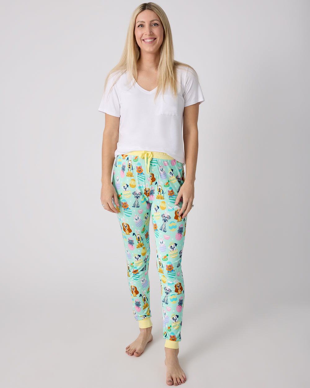 Woman wearing the Disney Peekaboo Pets Women's Pajama Pants with a white pajama top