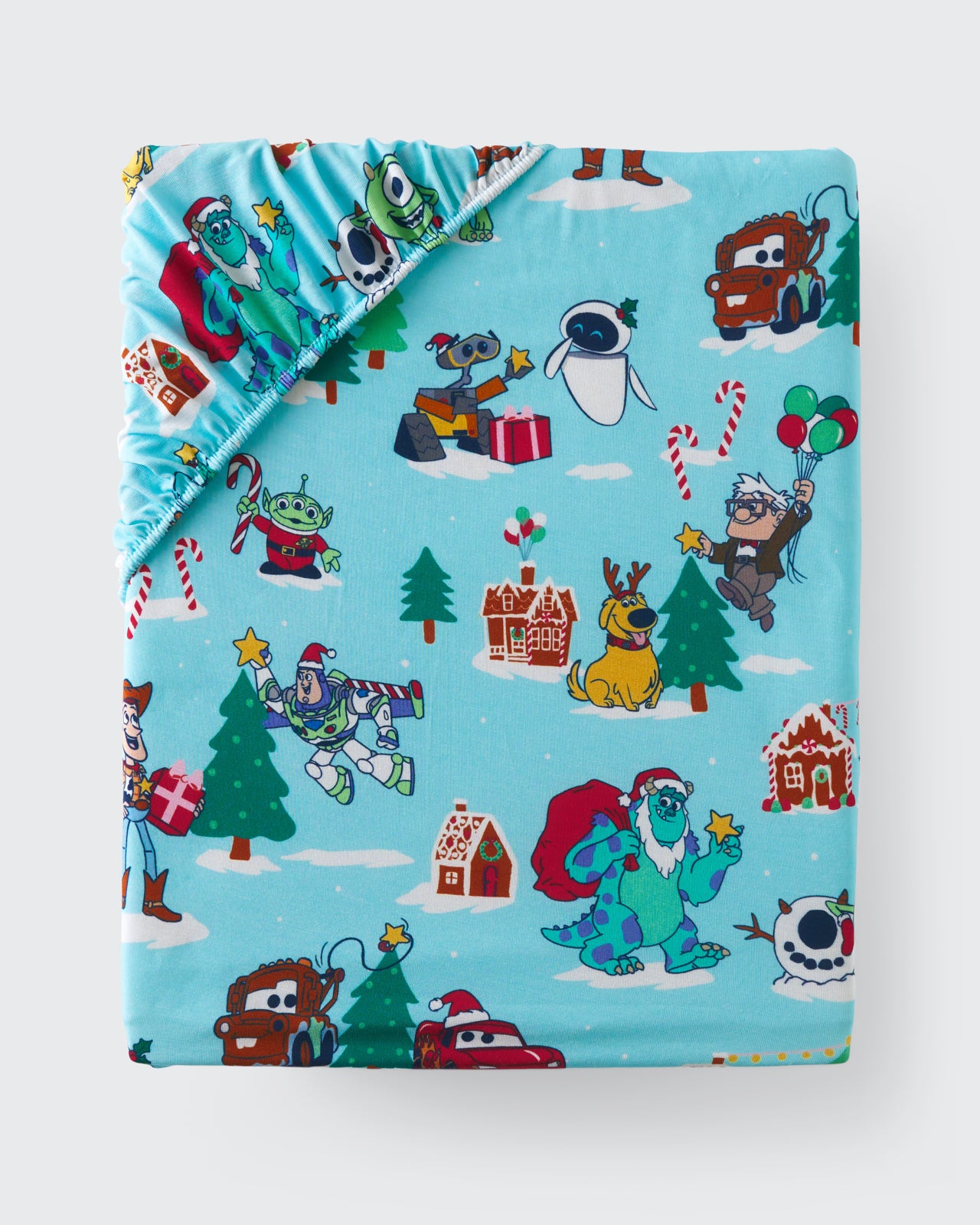 Flat lay of the Disney & Pixar Christmas Village Fitted Crib Sheet