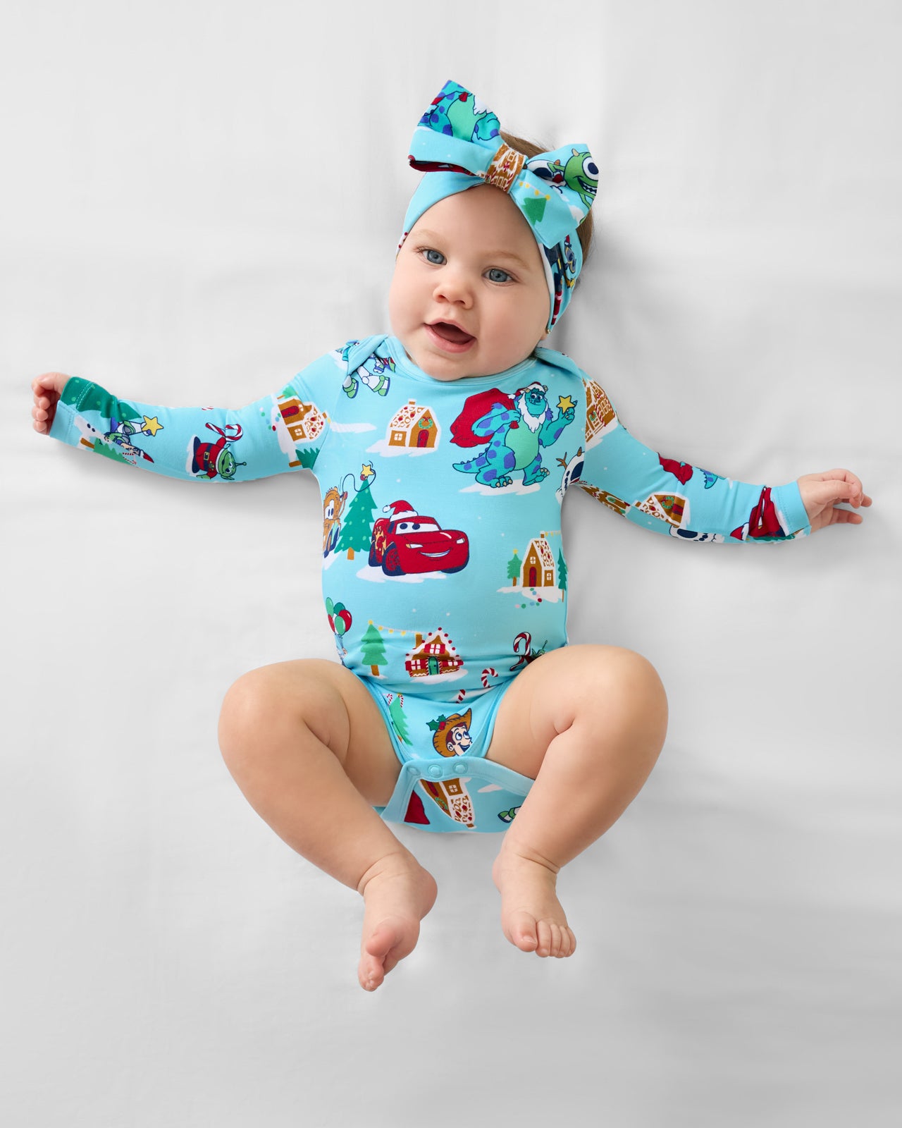 Aerial view of baby wearing the Disney & Pixar Christmas Village Bodysuit