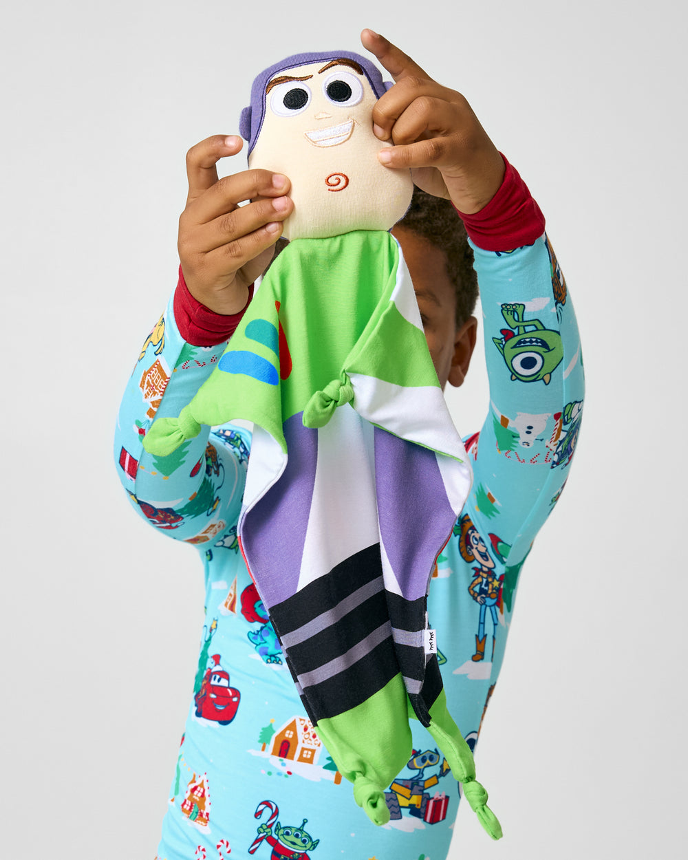 Child holding up the Disney Toy Story Buzz Lightyear Lovey