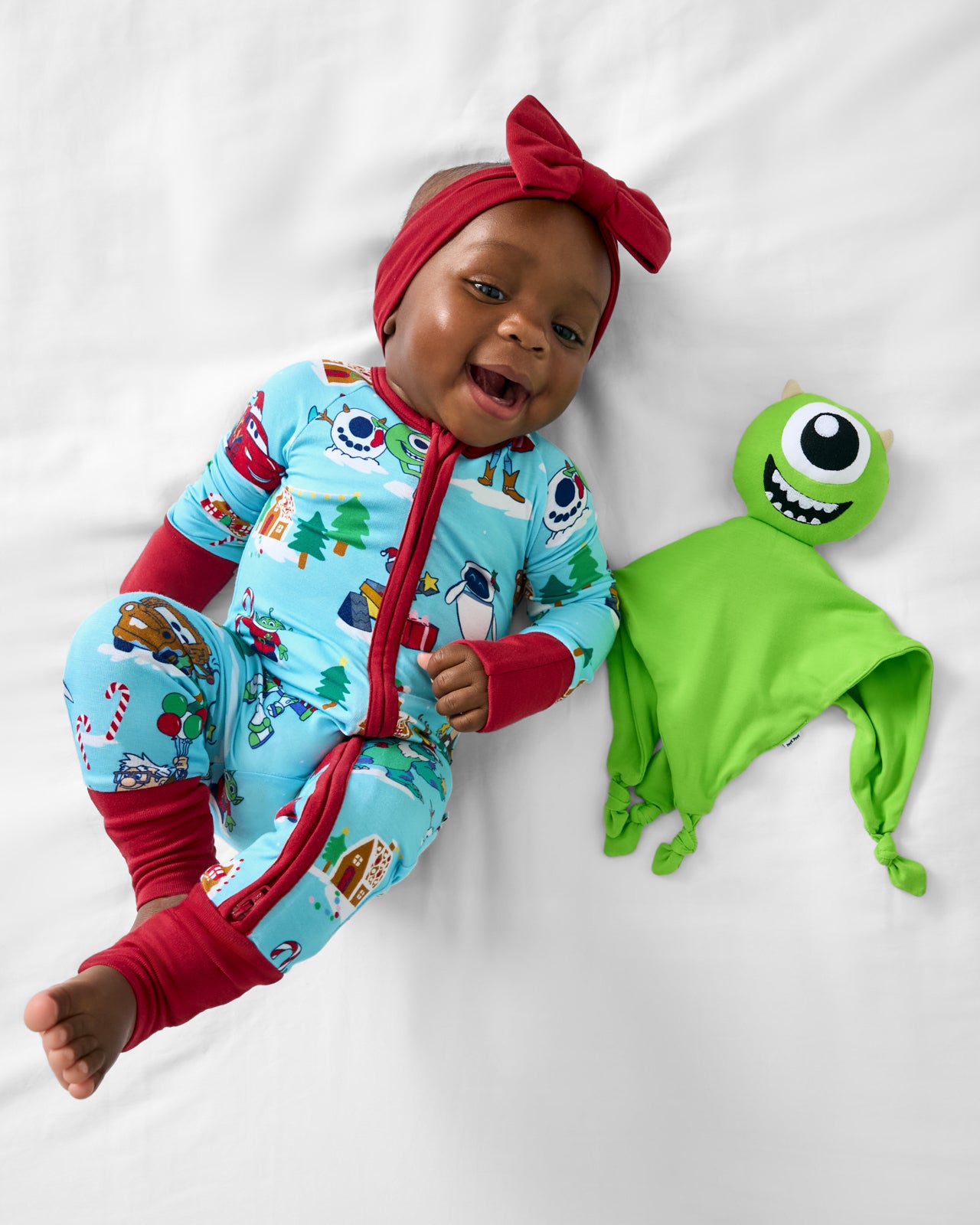 Baby laying with the Disney Monsters, Inc. Mike Wazowski Lovey
