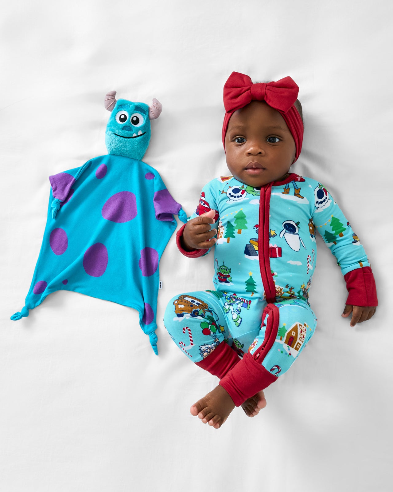 Baby laying with the Disney Monsters, Inc. Sulley Lovey