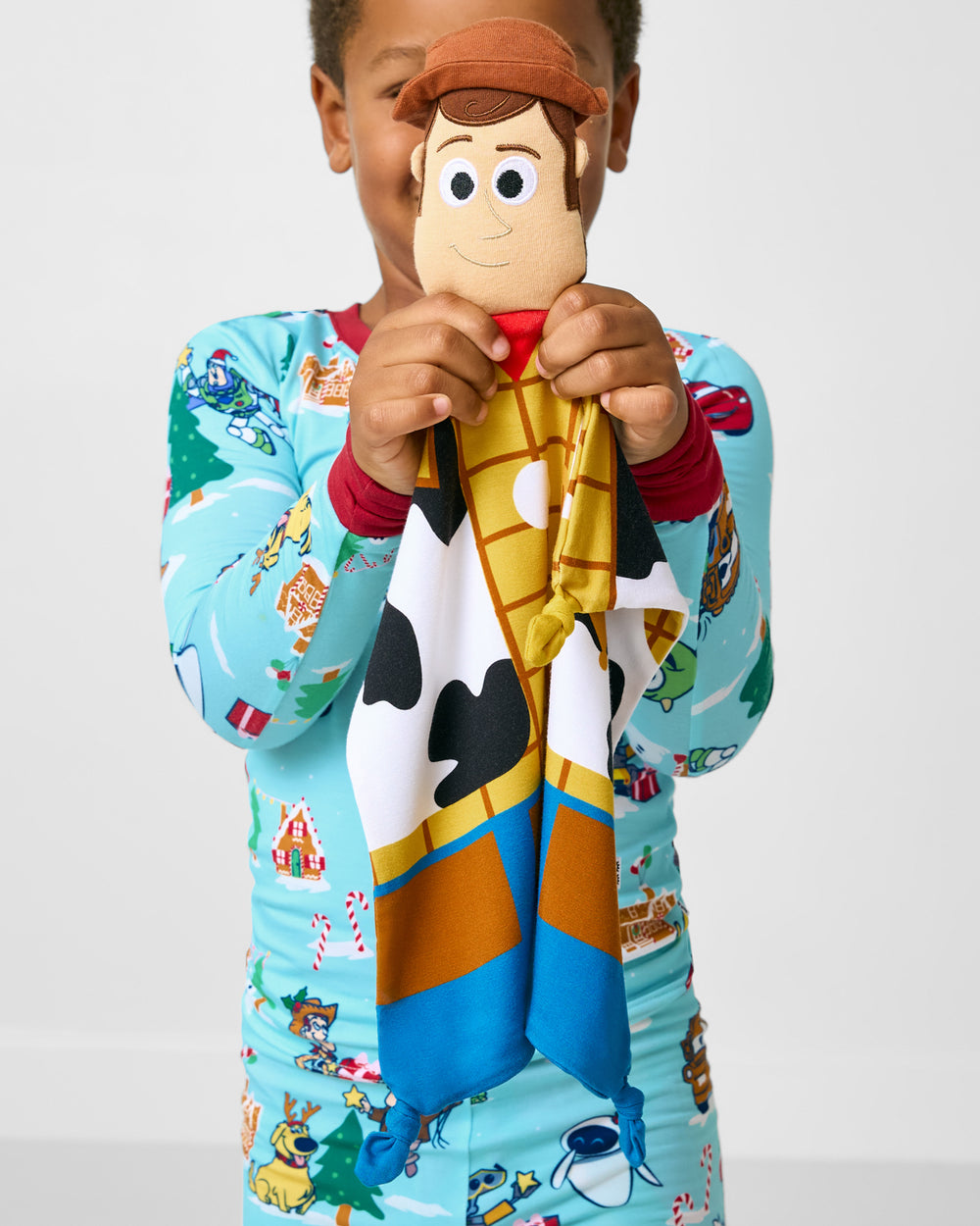 Boy holding up the Disney Toy Story Woody Lovey