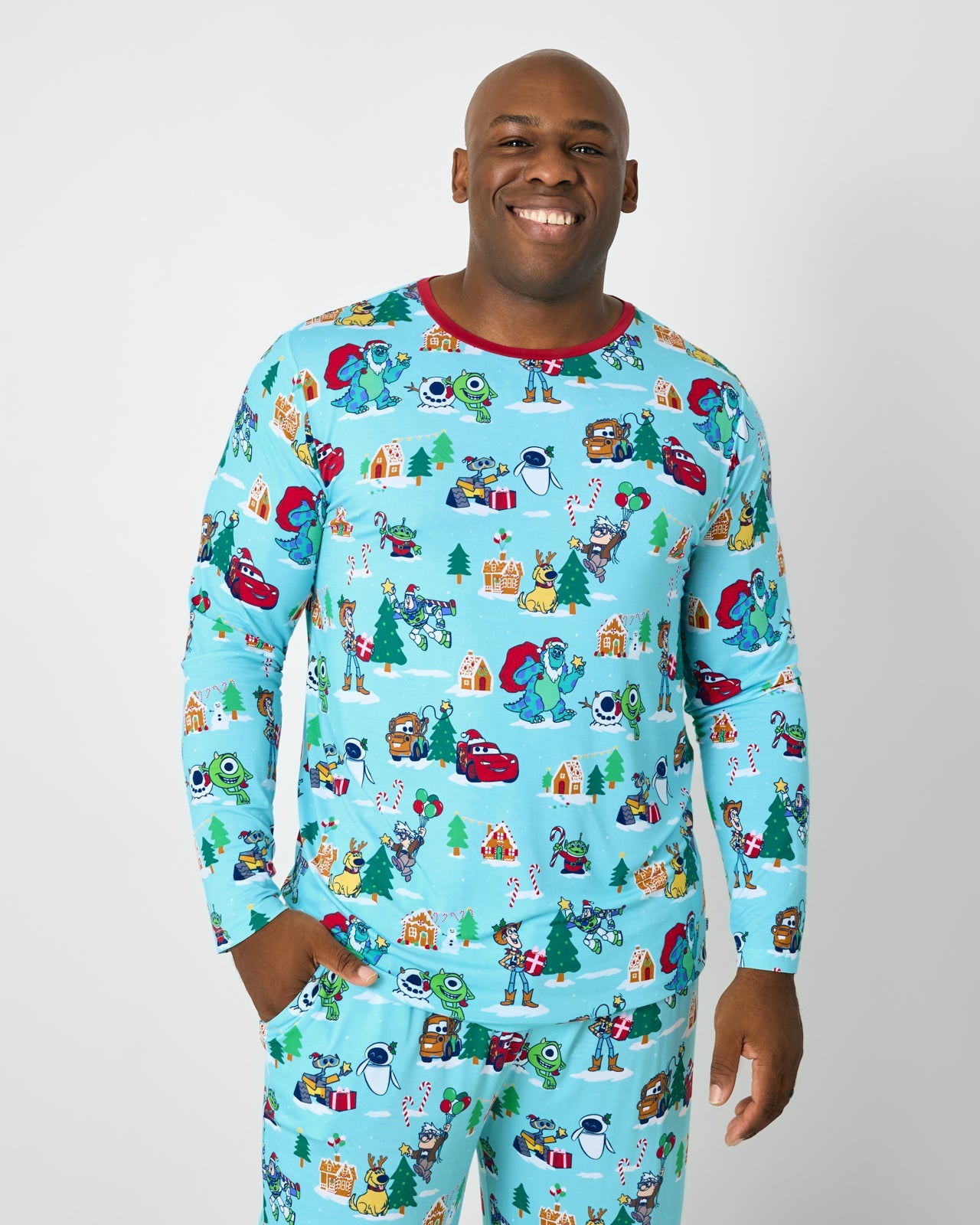 Man wearing the Disney & Pixar Christmas Village Men's Long Sleeve Pajama Top