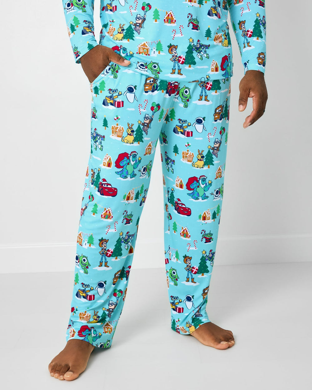 Man wearing the Disney & Pixar Christmas Village Men's Pajama Pants