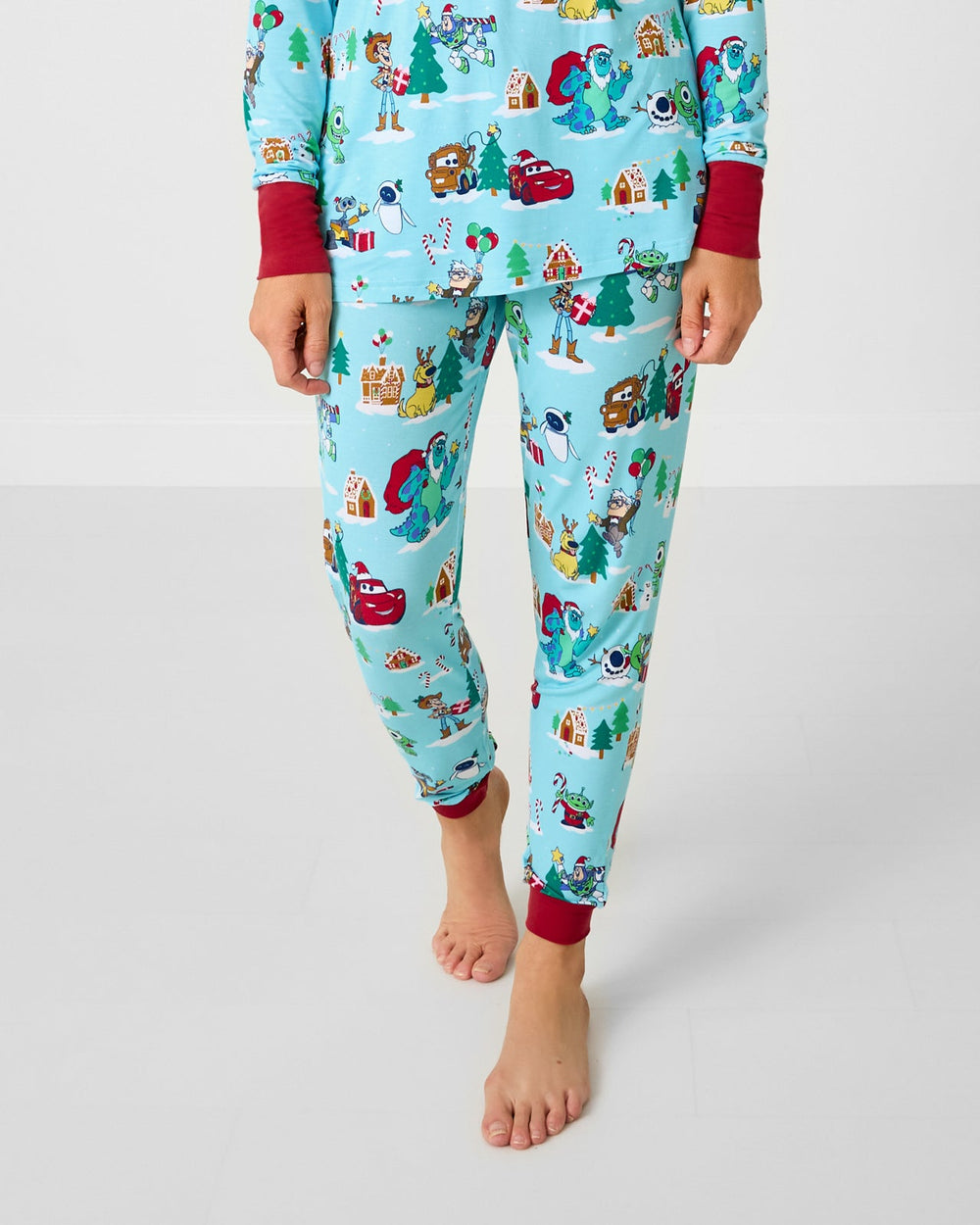 Woman wearing the Disney & Pixar Christmas Village Women's Pajama Pants