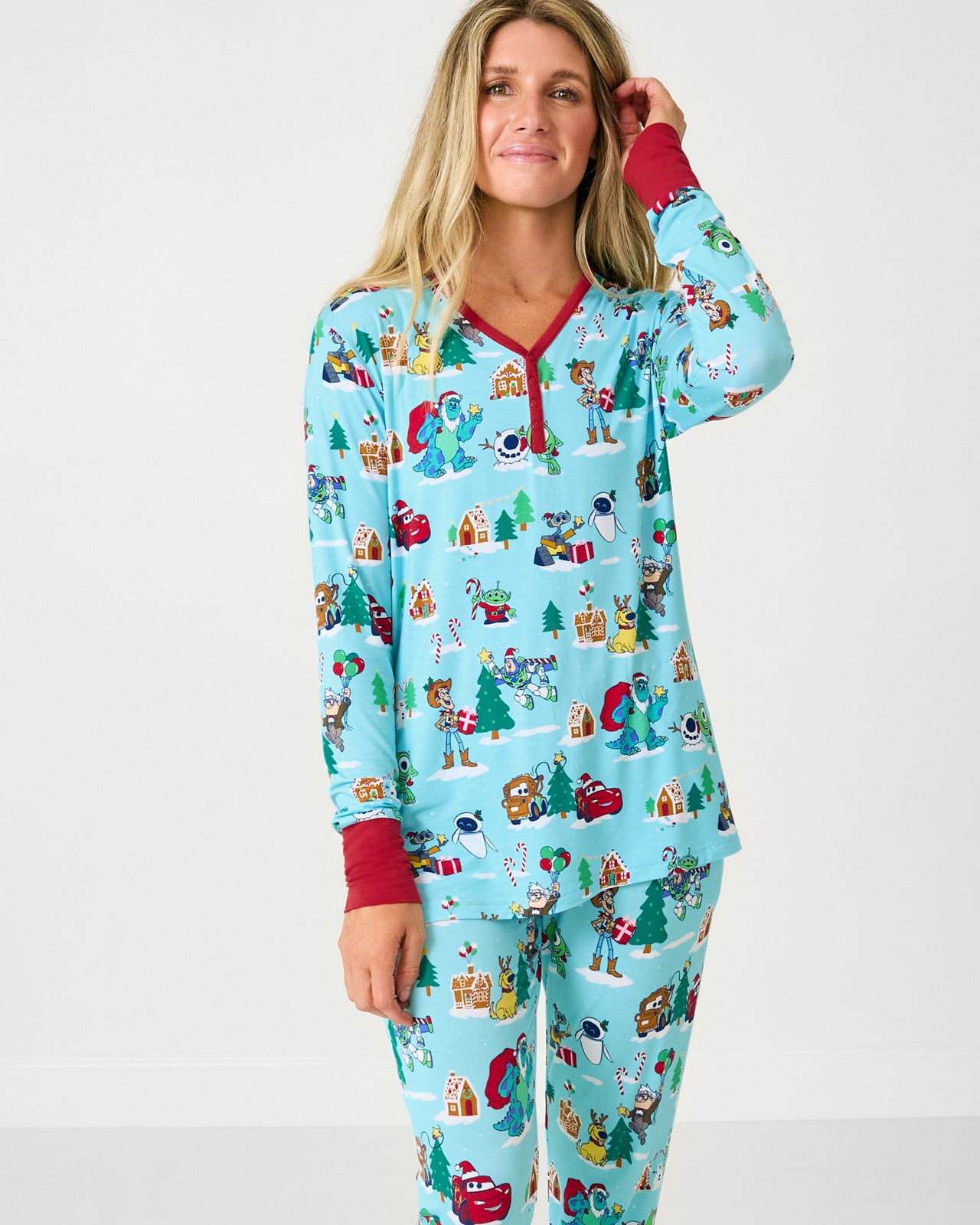 Woman wearing the Disney & Pixar Christmas Village Women's Long Sleeve Pajama Top