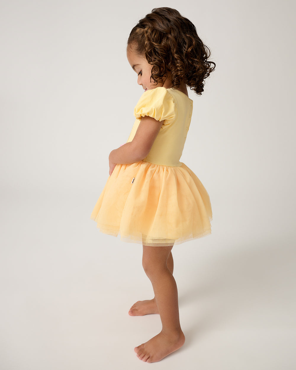 Side view of toddler wearing the Disney Princess Belle Dress with Bodysuit