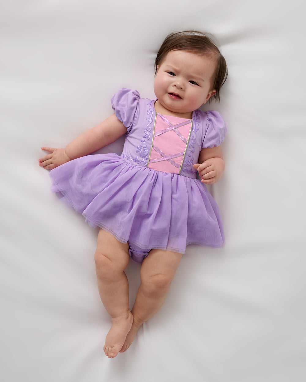 Aerial view of baby wearing the Disney Princess Rapunzel Dress with Bodysuit