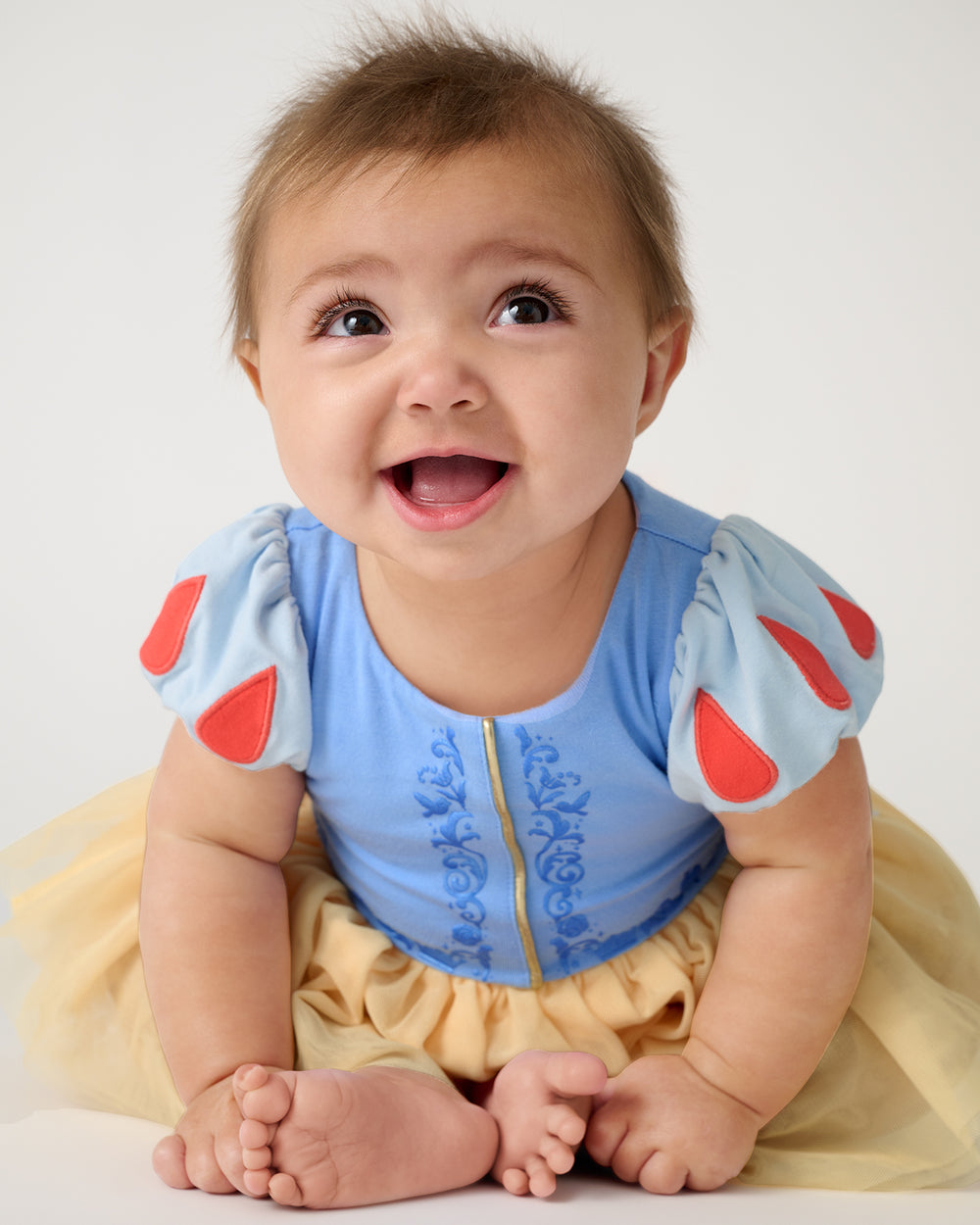 Sitting baby wearing the Disney Princess Snow White Dress with Bodysuit