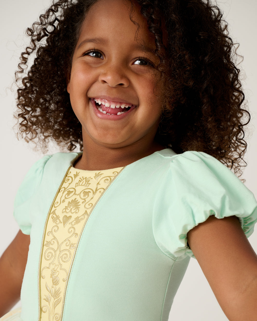 Close up of girl wearing the Disney Princess Tiana Dress