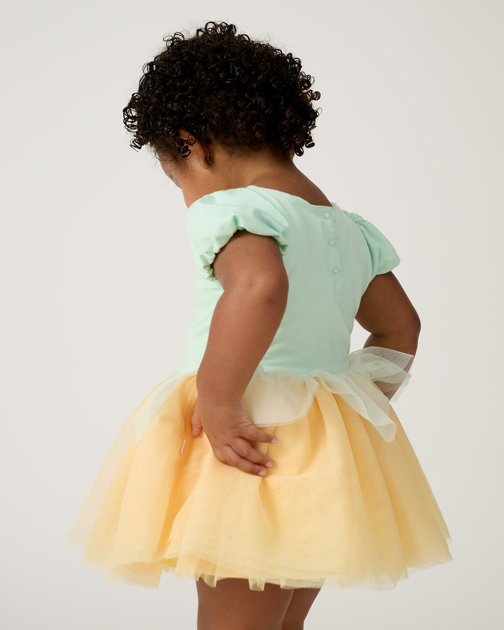Back view of toddler wearing the Disney Princess Tiana Dress with Bodysuit