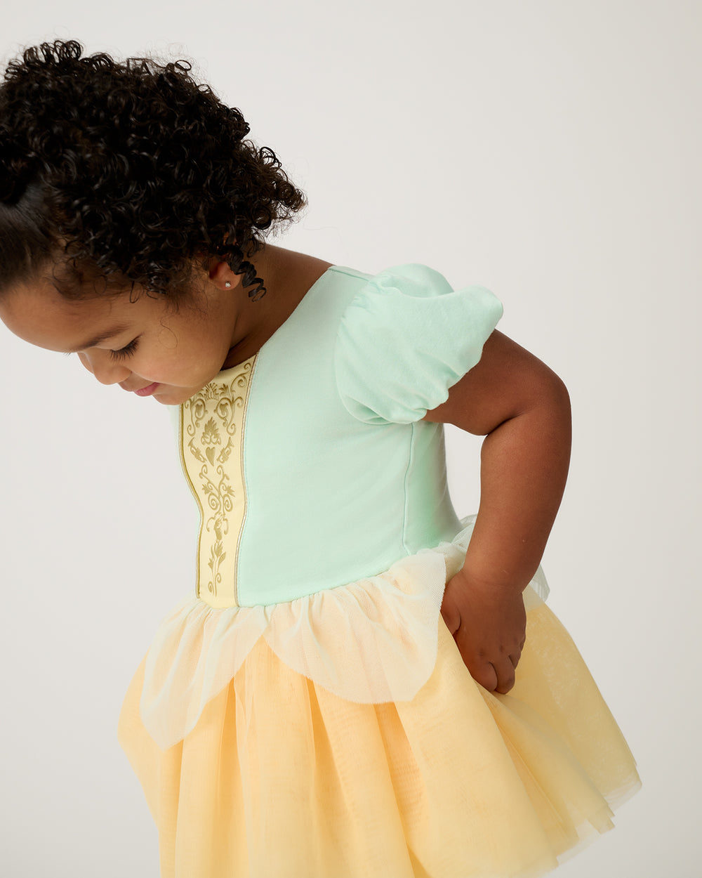 Close up of toddler wearing the Disney Princess Tiana Dress with Bodysuit