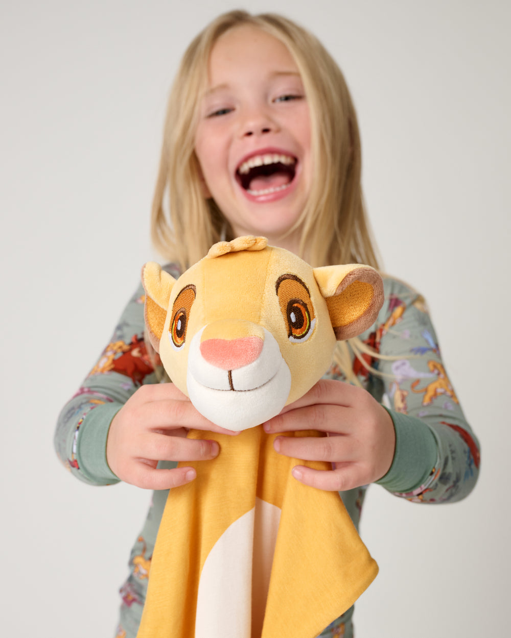 Girl holding up the Disney Simba Lovey