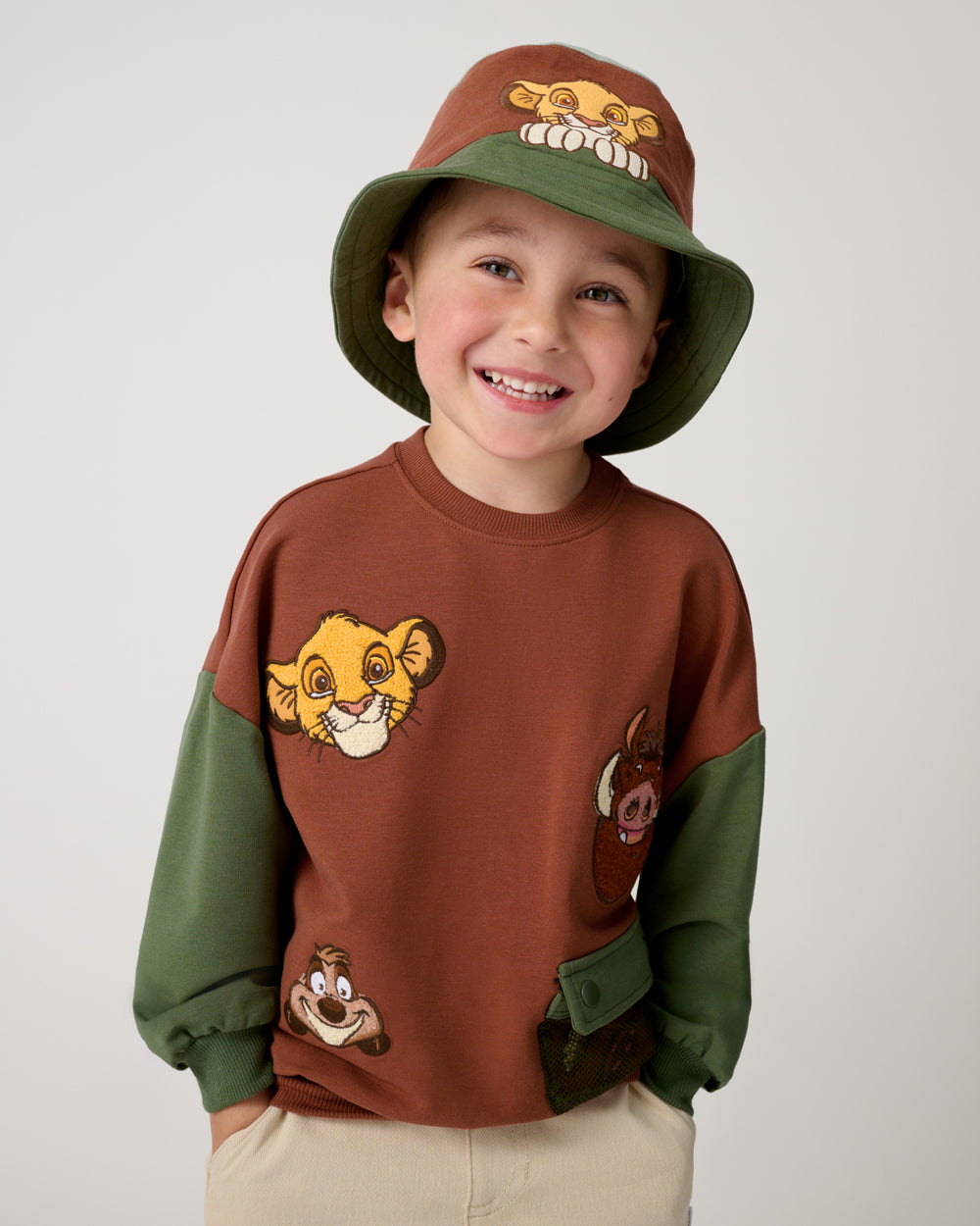 Boy wearing the Disney Simba Bucket Hat and a Lion King crewneck
