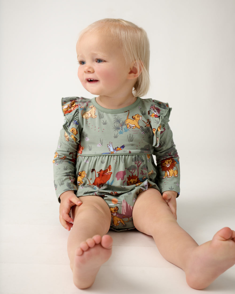 Sitting baby wearing the Disney Simba's Safari Bubble Romper