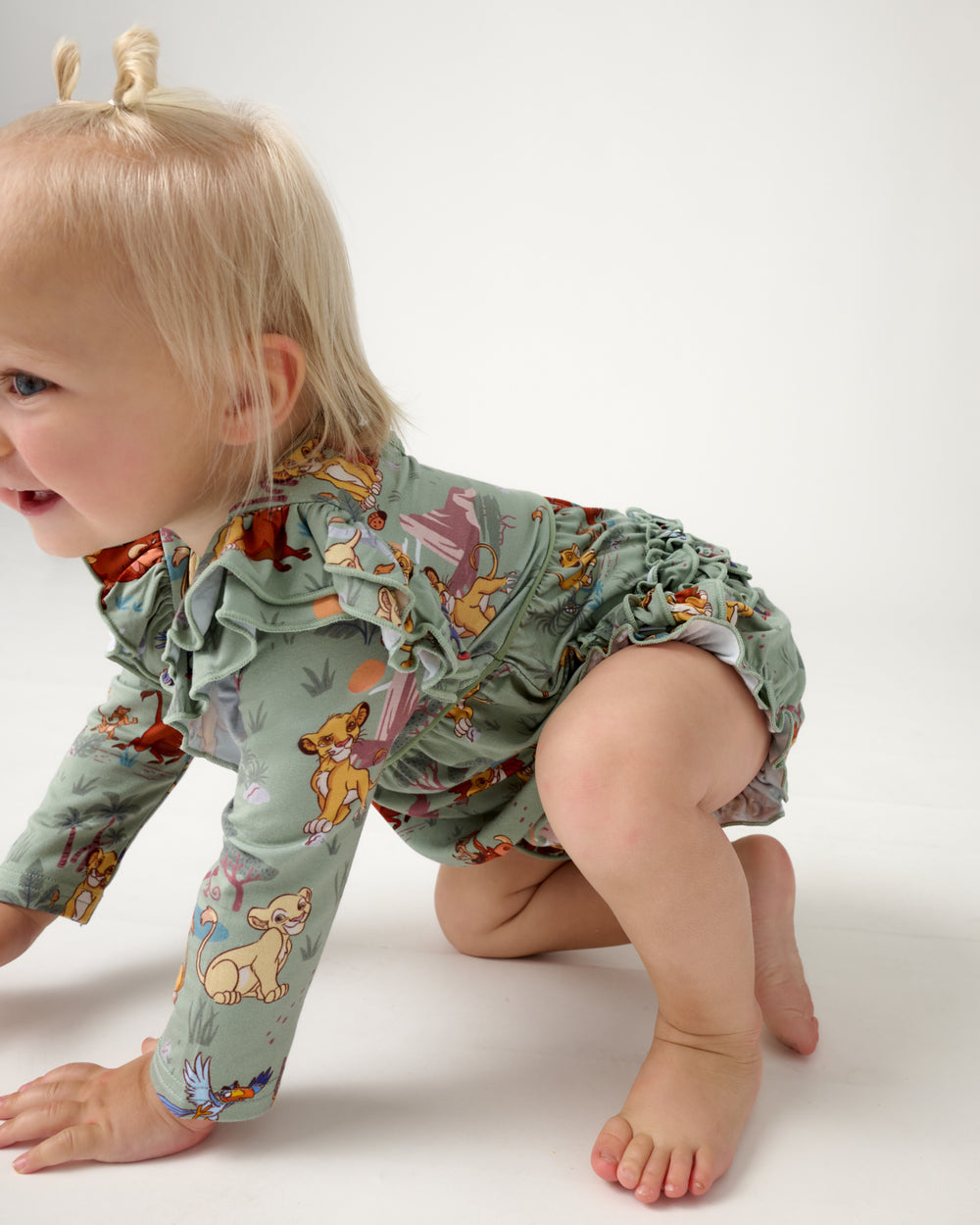 Crawling baby wearing the Disney Simba's Safari Bubble Romper
