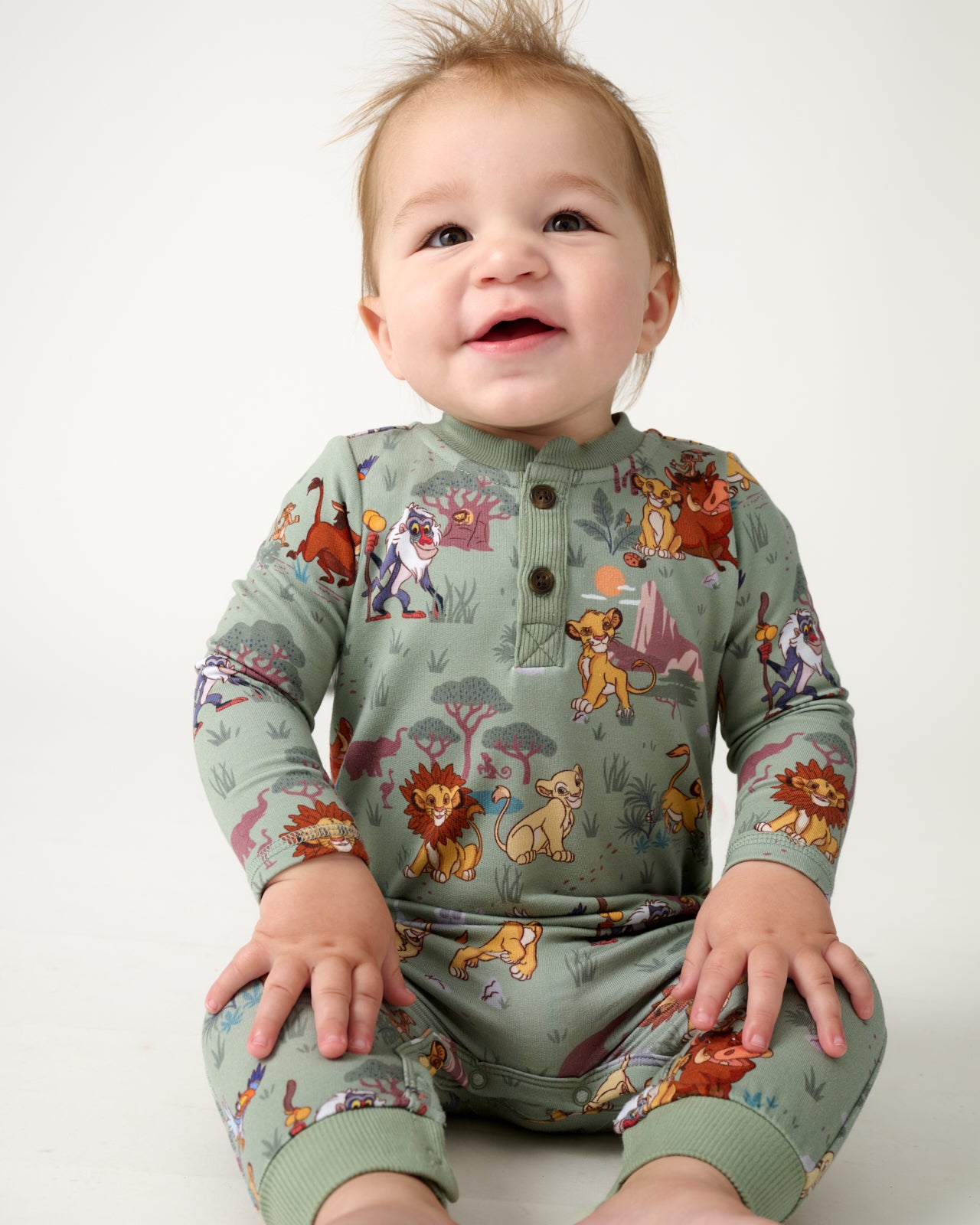 Sitting baby wearing the Disney Simba's Safari Henley Romper