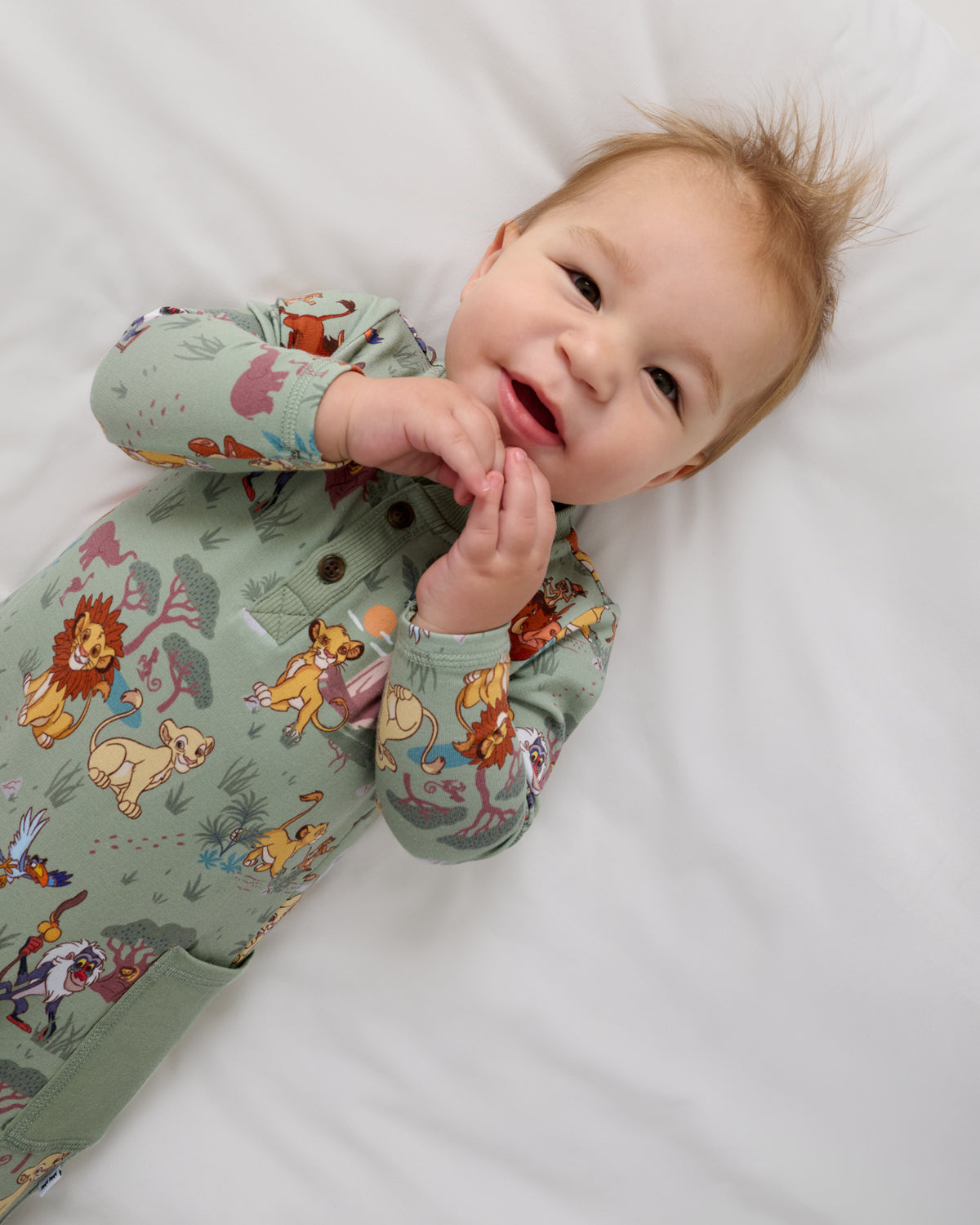 Close up overhead view of baby wearing the Disney Simba's Safari Henley Romper