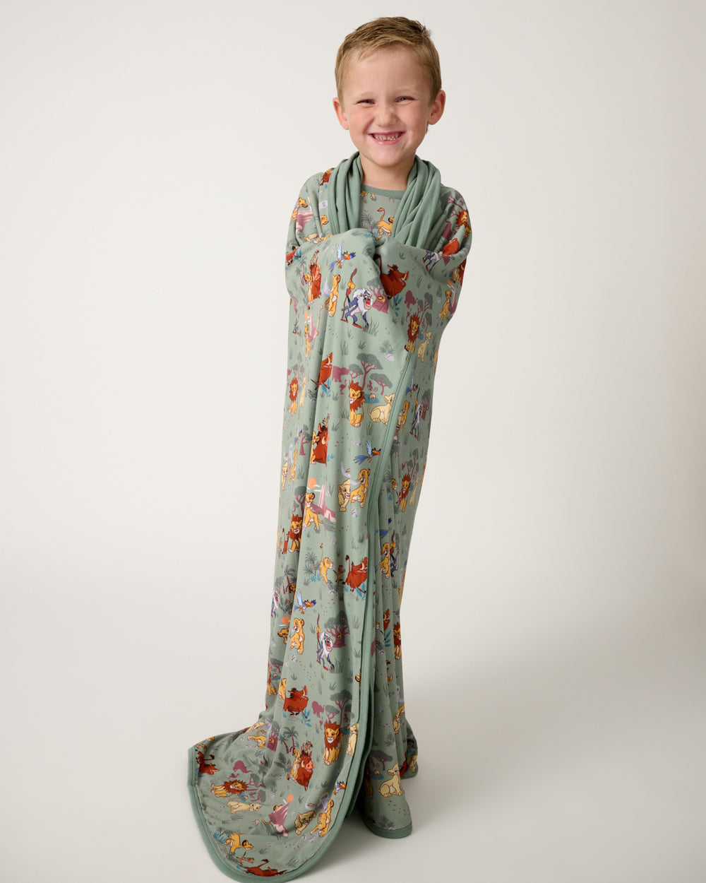 Standing child wrapped in the Disney Simba's Safari Large Cloud Blanket®