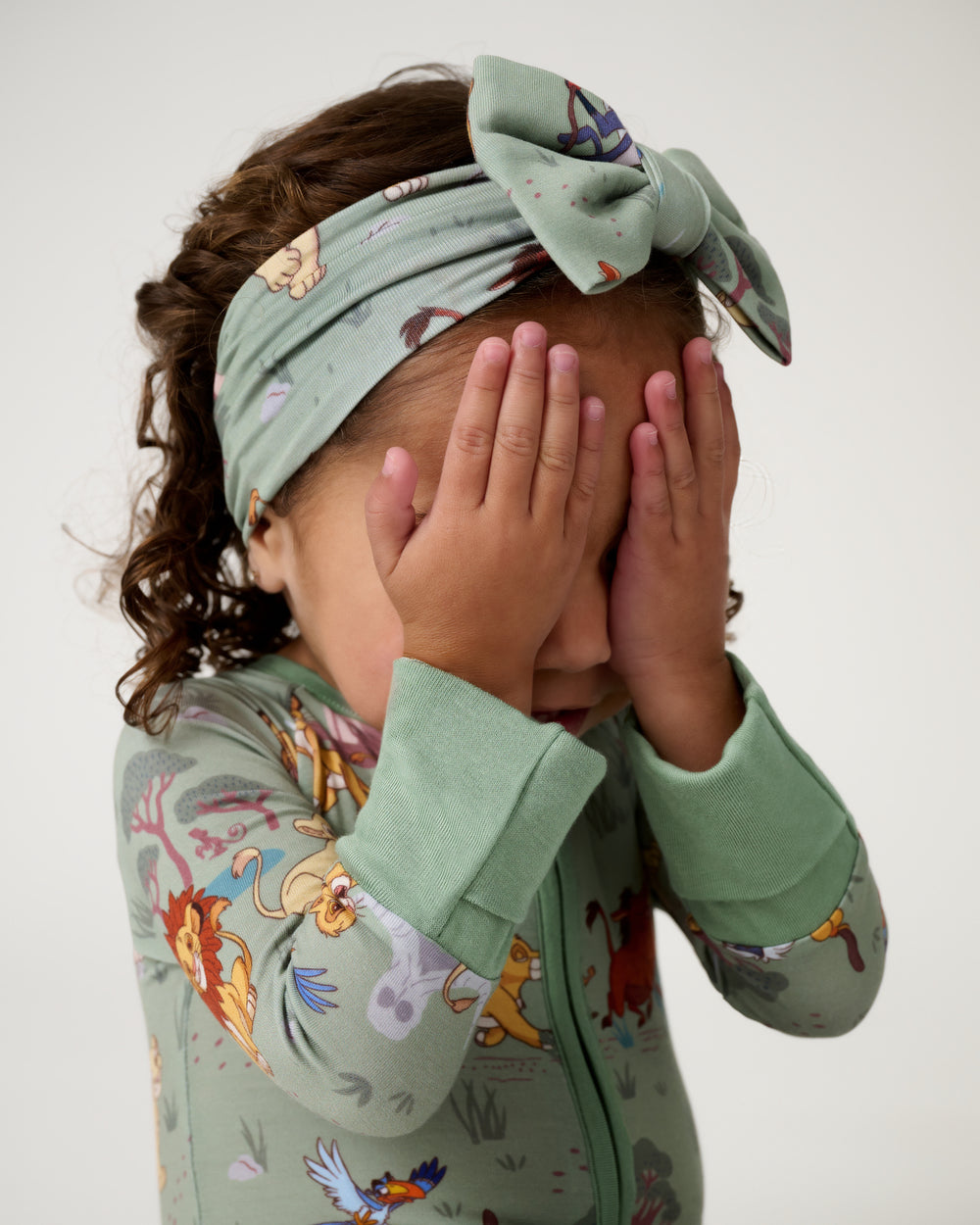 Posing girl wearing the Disney Simba's Safari Luxe Bow Headband