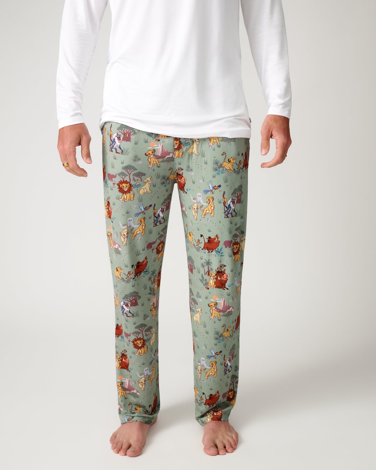 Man wearing the Disney Simba's Safari Men's Pajama Pants with a white shirt