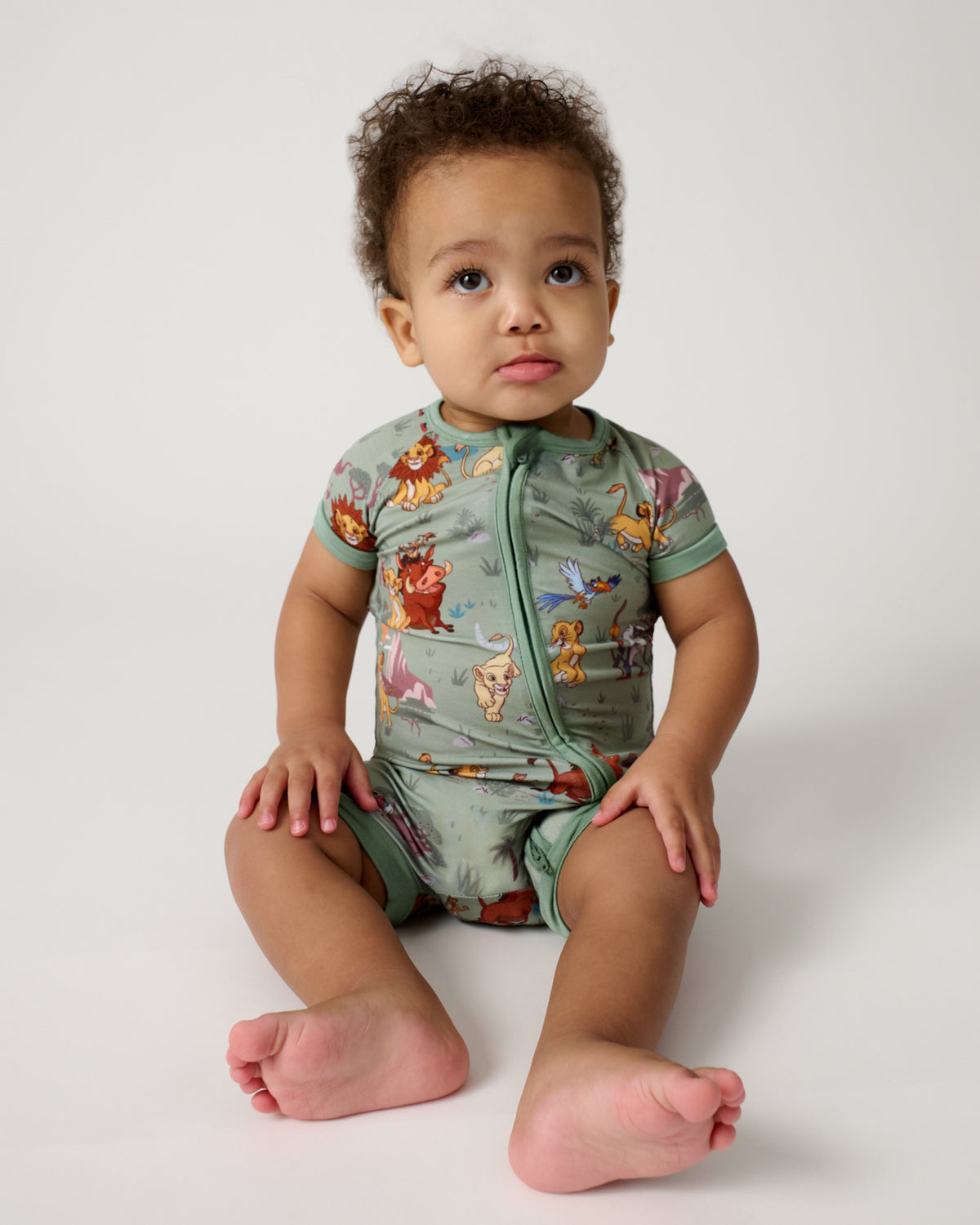 Sitting baby wearing the Disney Simba's Safari Shorty Zippy