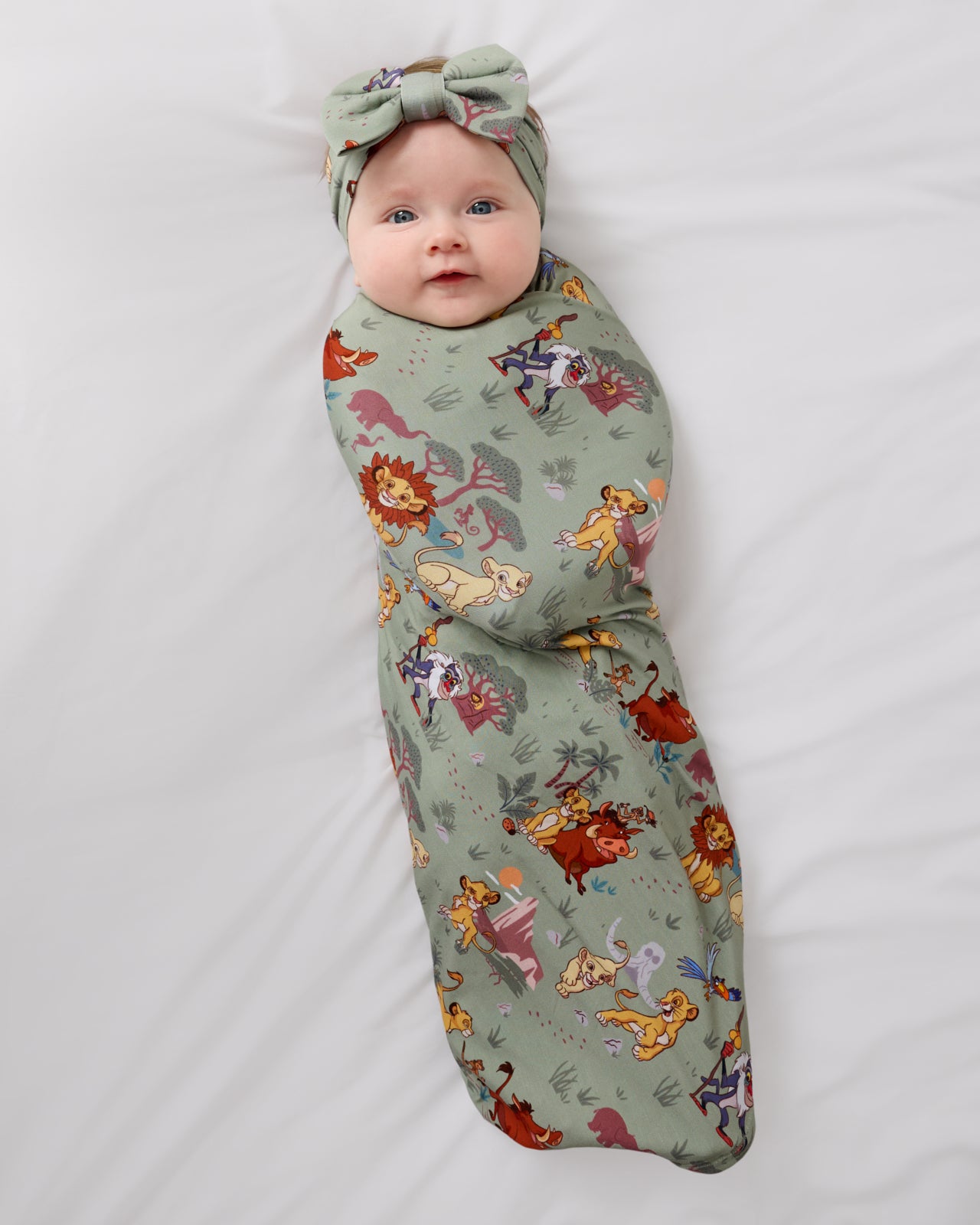 Aerial view of the Disney Simba's Safari Swaddle & Luxe Bow Headband Set