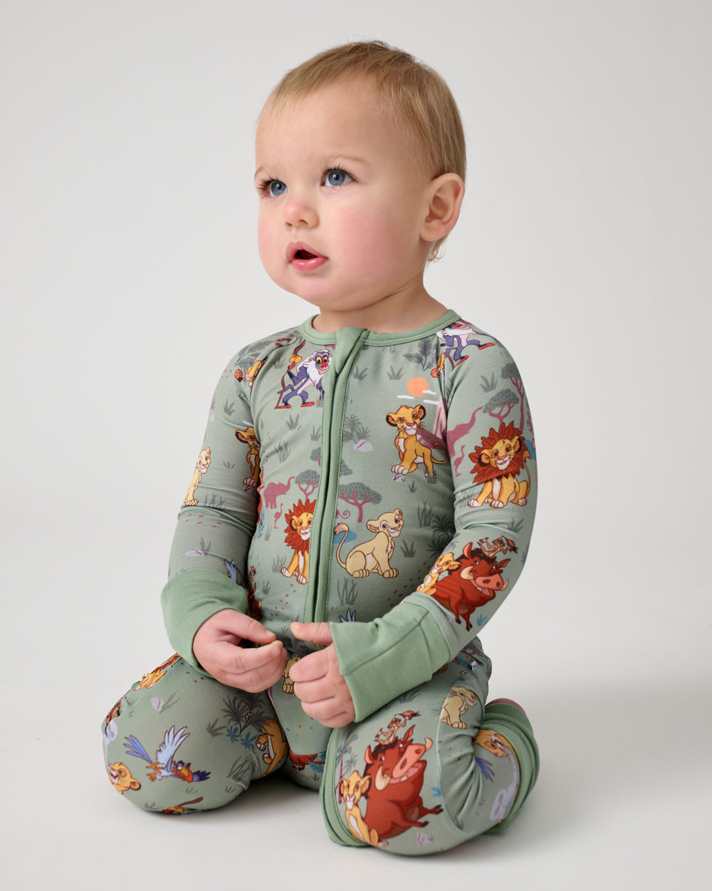 Sitting baby wearing the Disney Simba's Safari Zippy