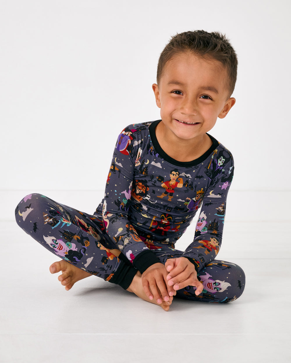 Sitting child wearing the Disney Villains Two-Piece Pajama Set