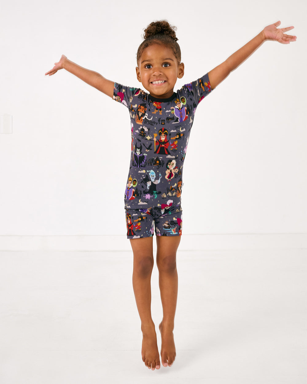 Jumping girl wearing the Disney Villains Two-Piece Short Sleeve & Shorts Pajama Set