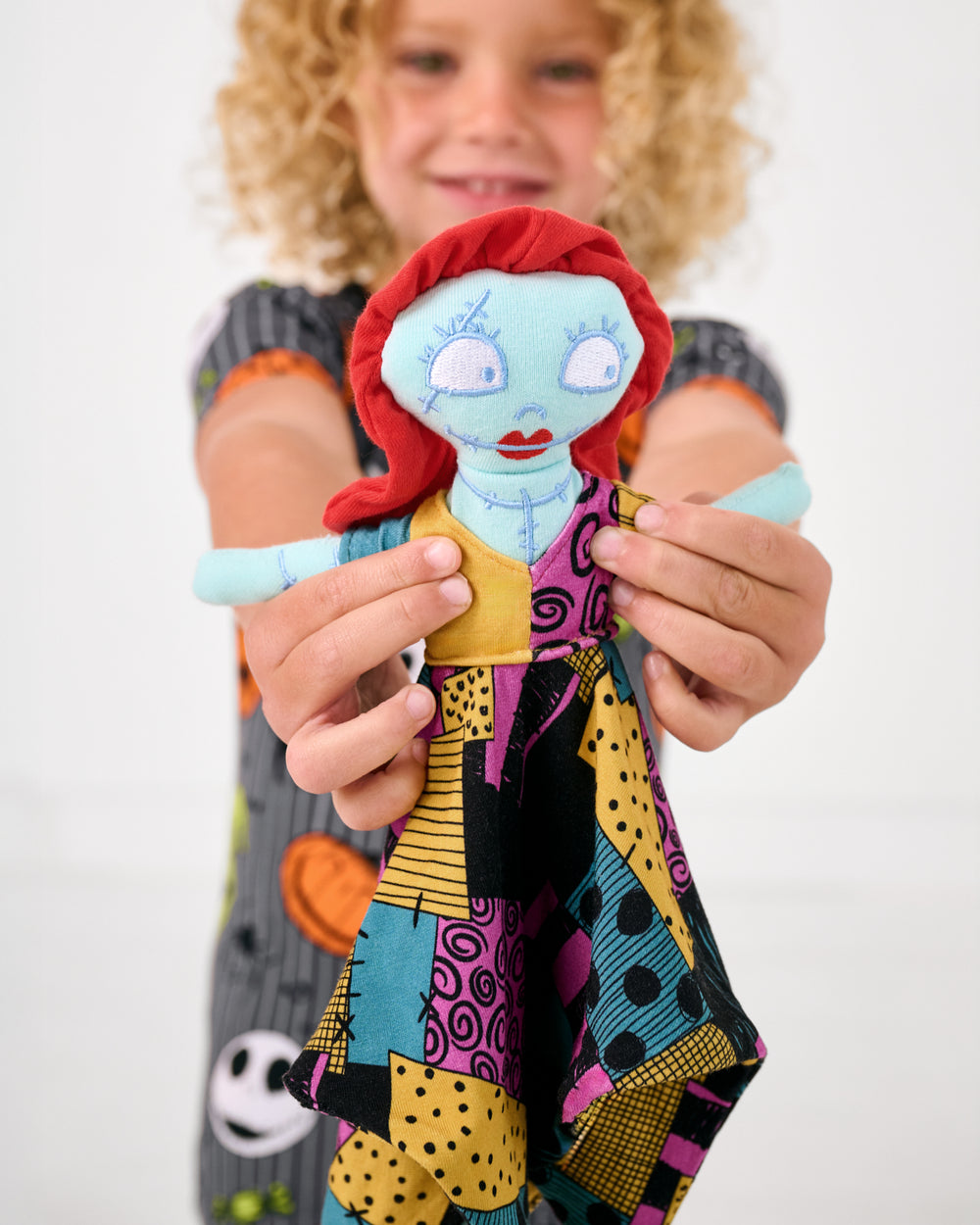 Child holding up the Disney Sally Lovey