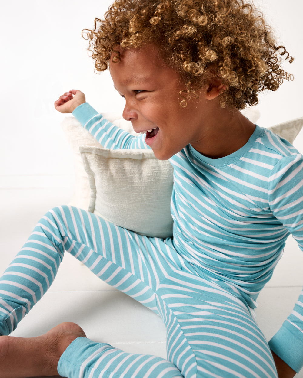 Close up of boy wearing the Dockside Stripe Two-Piece Pajama Set