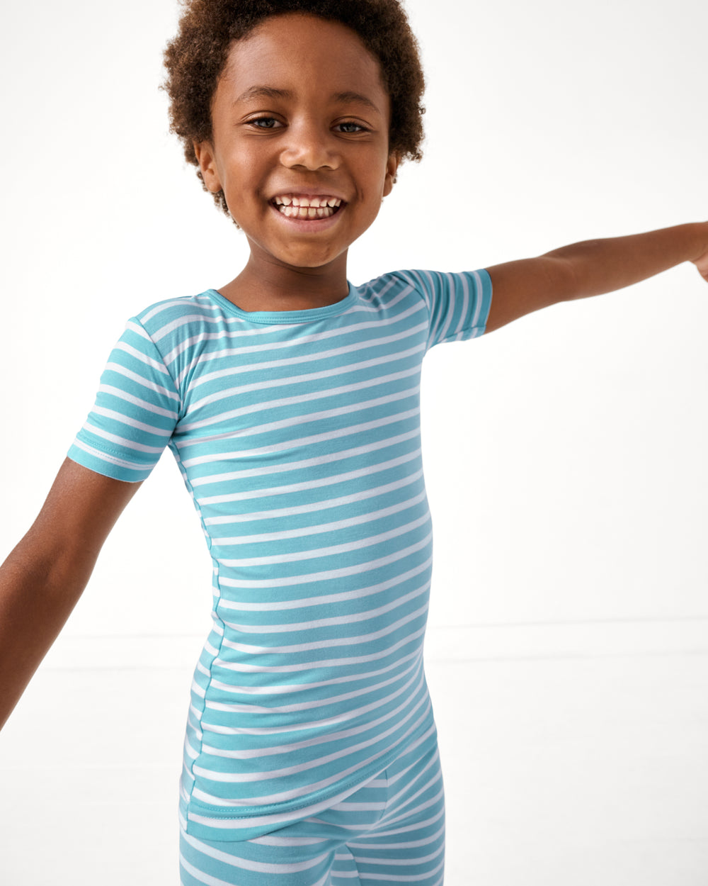 Close up of boy wearing the Dockside Stripe Two-Piece Short Sleeve & Shorts Pajama Set