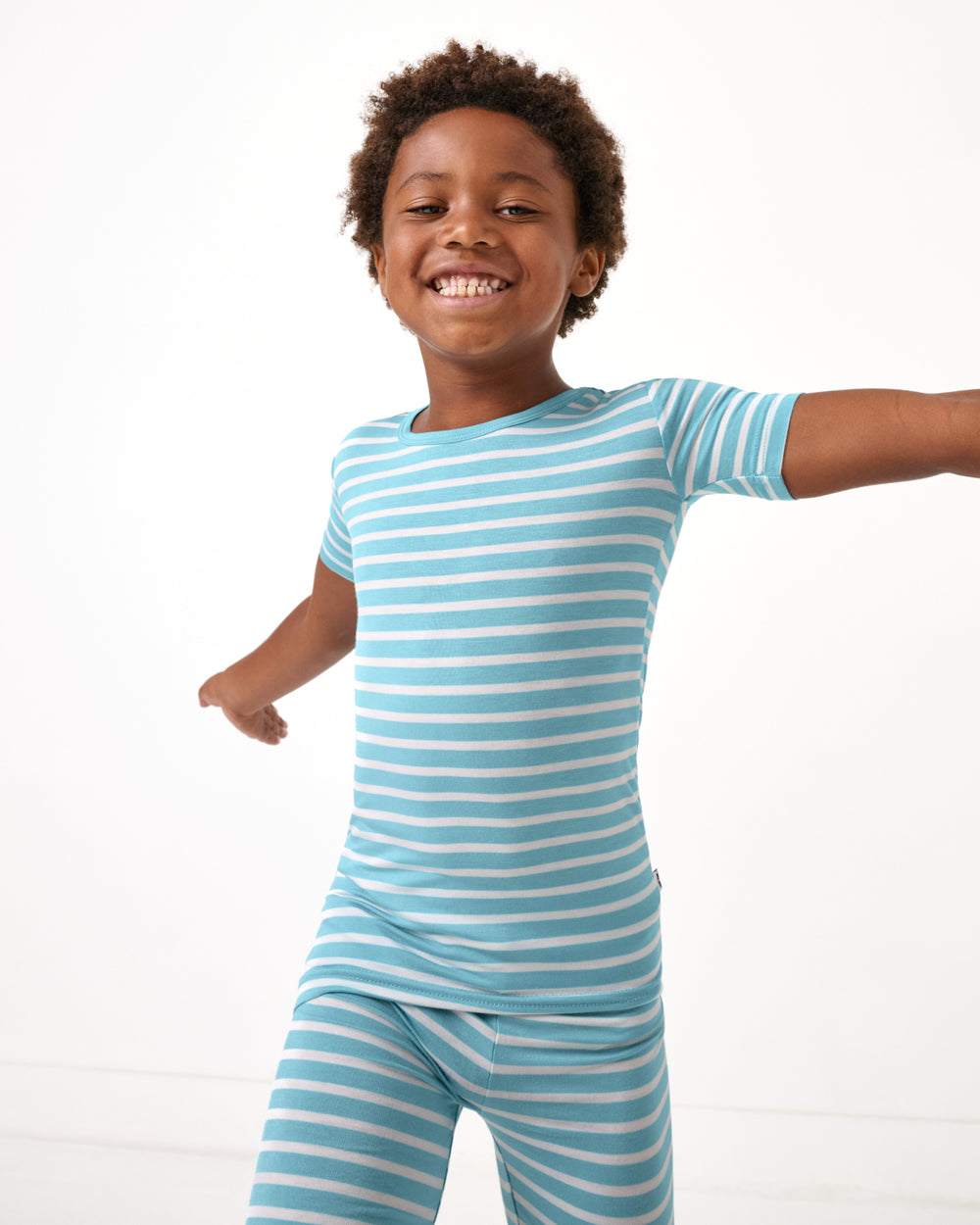Boy wearing the Dockside Stripe Two-Piece Short Sleeve & Shorts Pajama Set