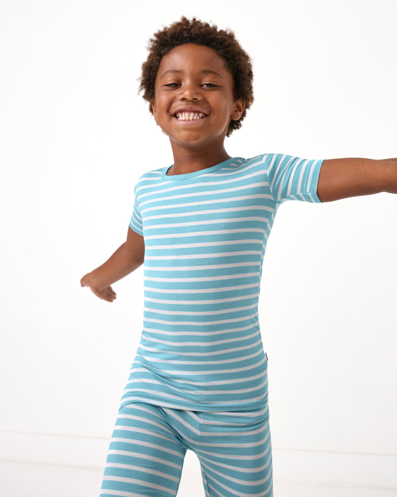 Boy wearing the Dockside Stripe Two-Piece Short Sleeve & Shorts Pajama Set