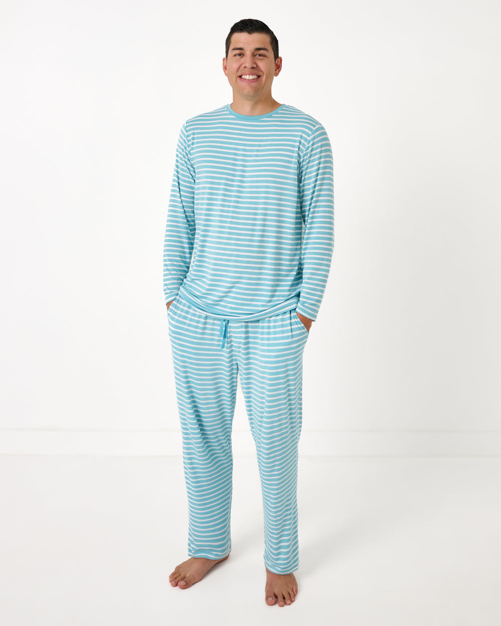 Man wearing the Dockside Stripe Men's Long Sleeve Pajama Top and Pants