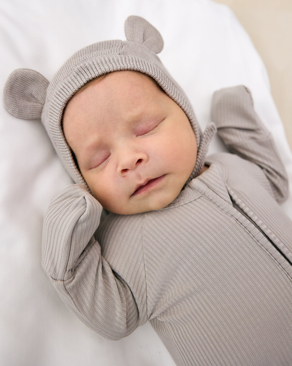 Sleeping newborn wearing the Dove Gray Bear Bonnet