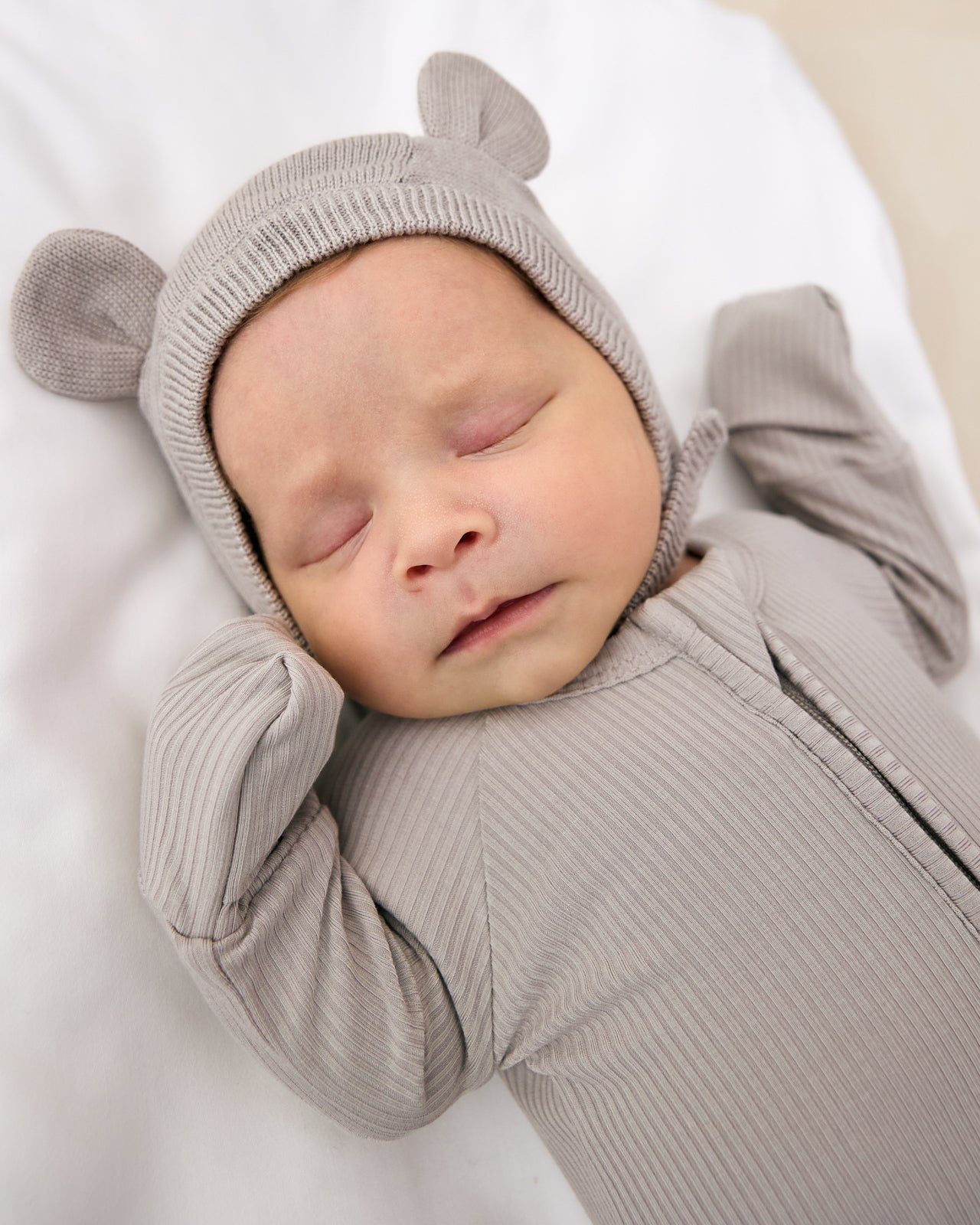 Sleeping newborn wearing the Dove Gray Bear Bonnet