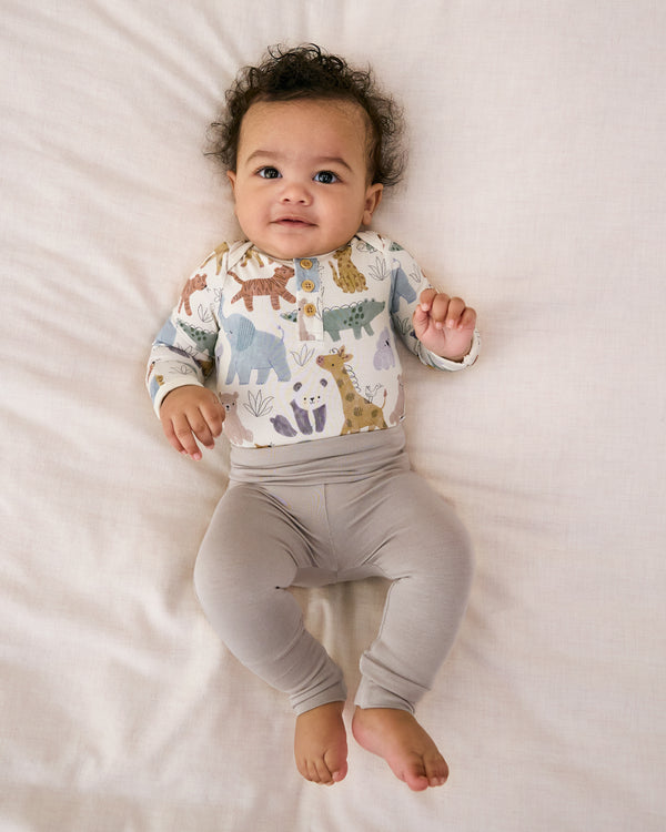 Newborn laying on a white blanket wearing the Dove Gray Fold-Over Legging
