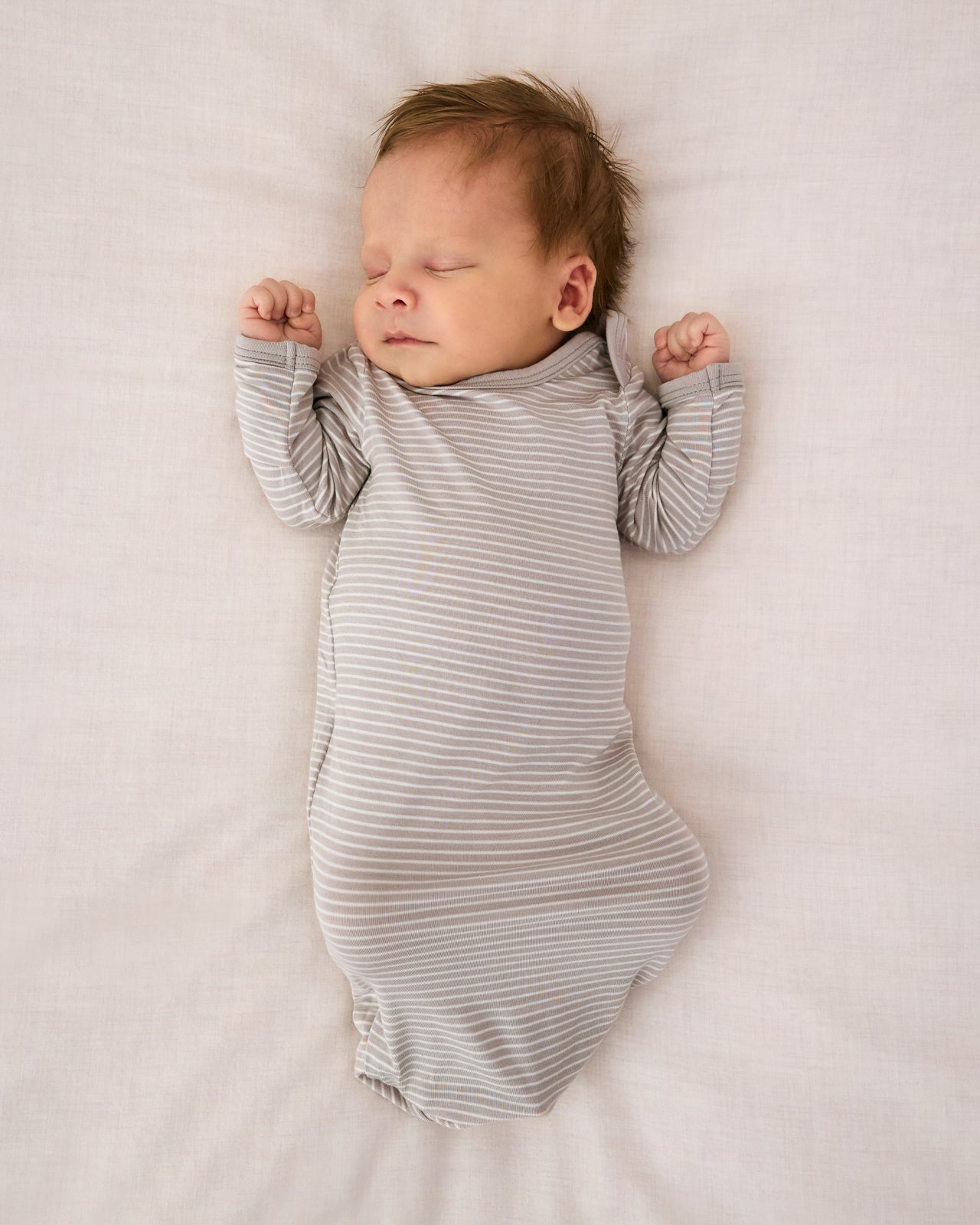 Aerial view of newborn wearing the Dove Gray Stripe Infant Gown