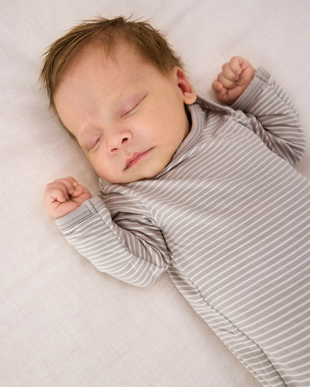 Close up of baby wearing the Dove Gray Stripe Infant Gown