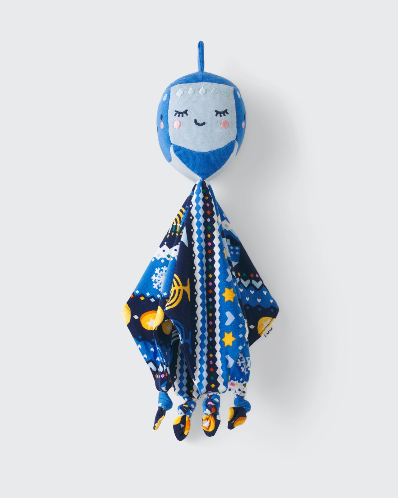 Flat lay of the Danny the Dreidel Sleepyhead Lovey