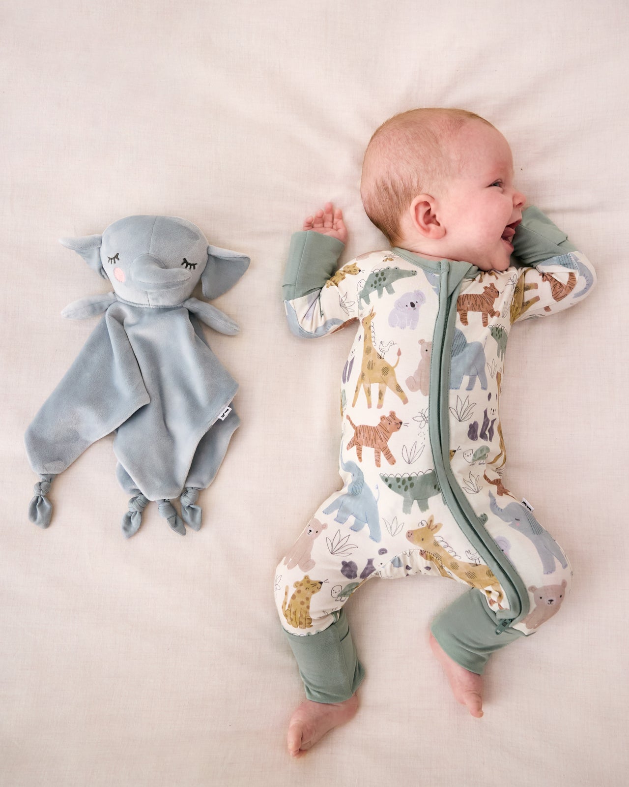 Baby laying with the Elephant Sleepyhead Lovey